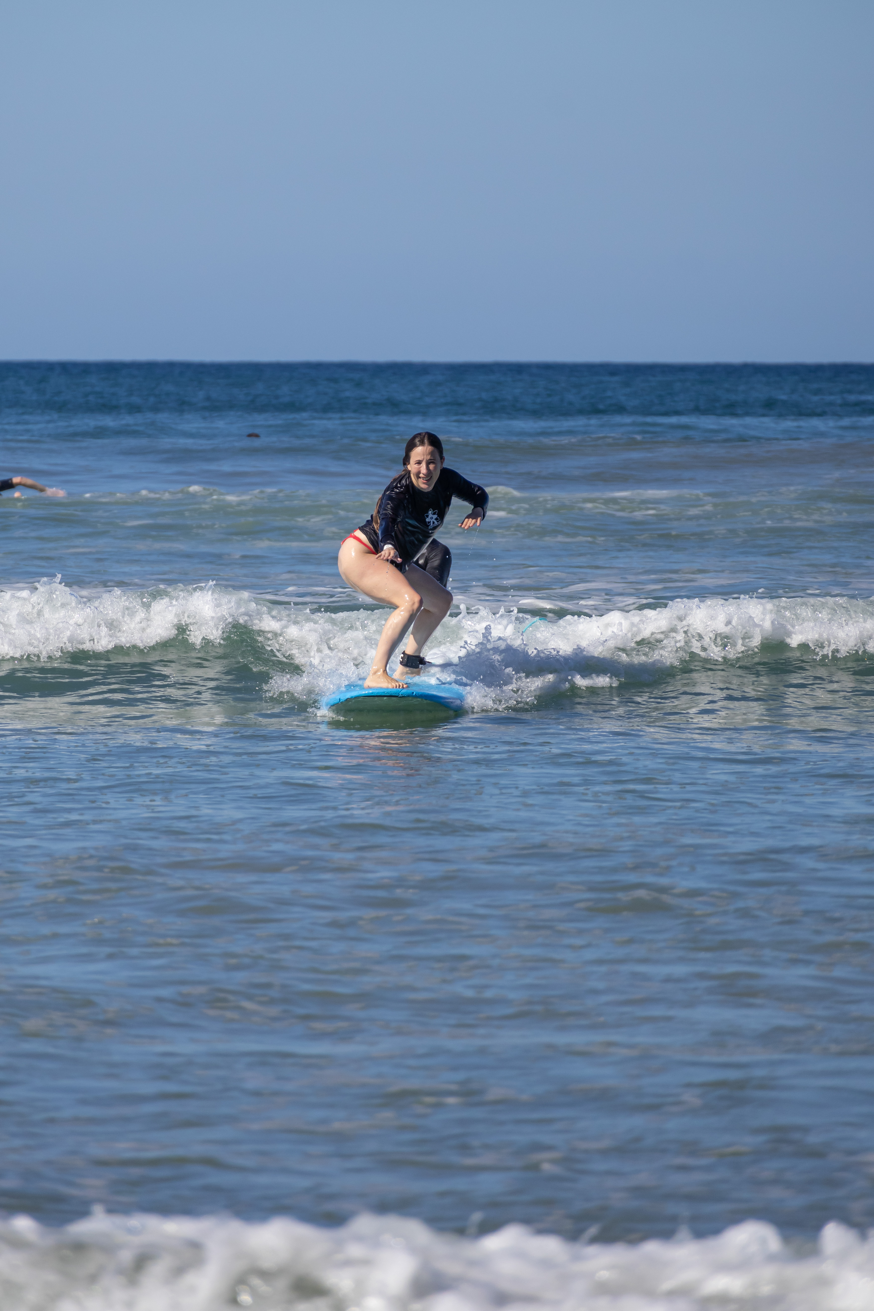 Girl surfing a wave in Santa Teresa